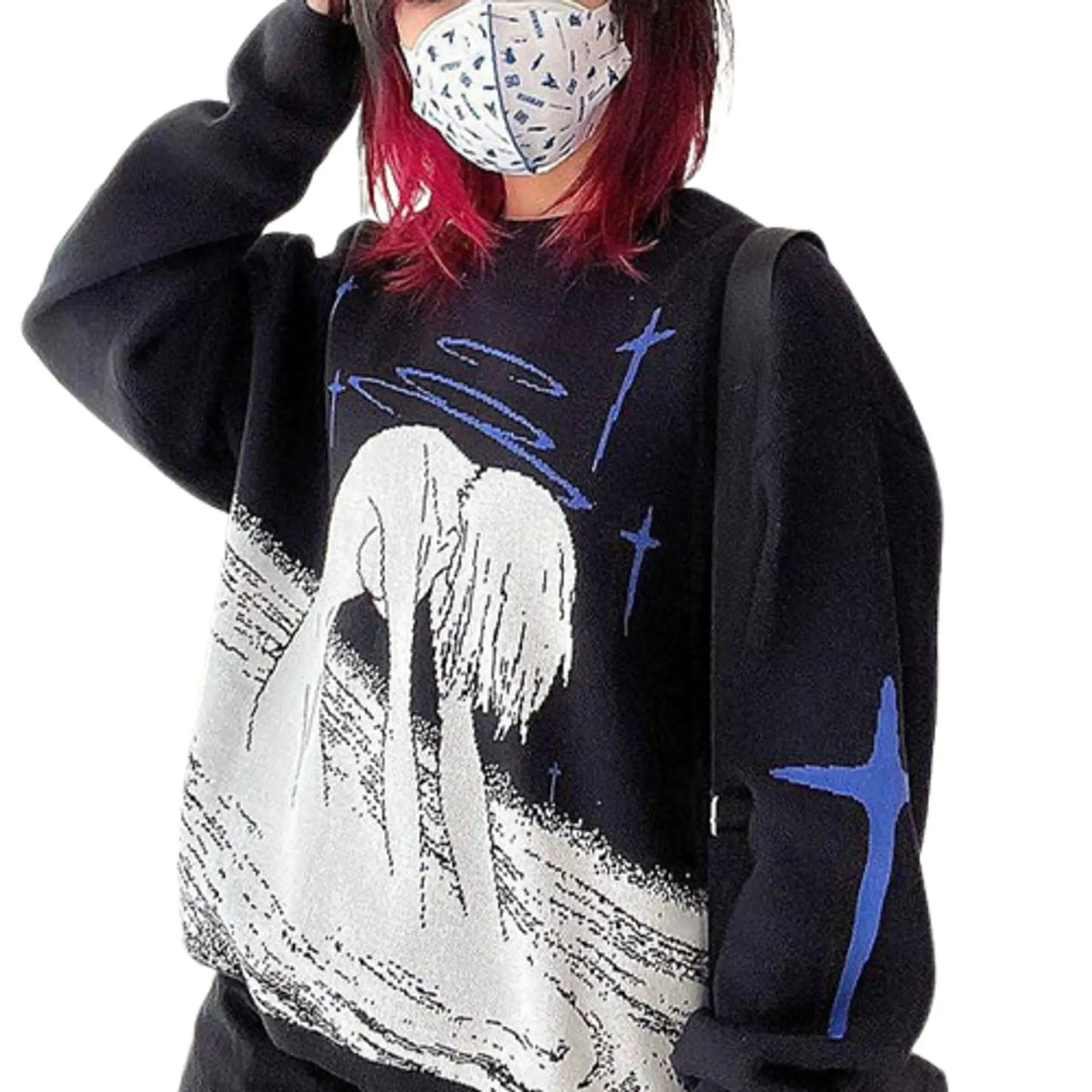 Women's printed pullover sweater with long sleeves, black with blue crosses and white graphic, front view on model