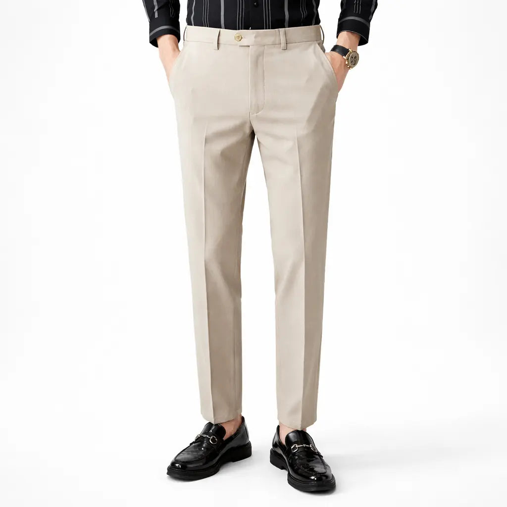 Beige dress pants worn by a person on a white background