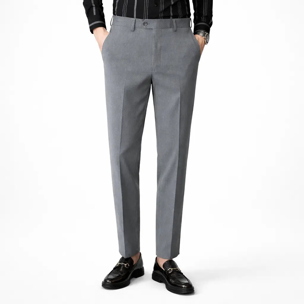 Gray dress pants worn by a person on a white background