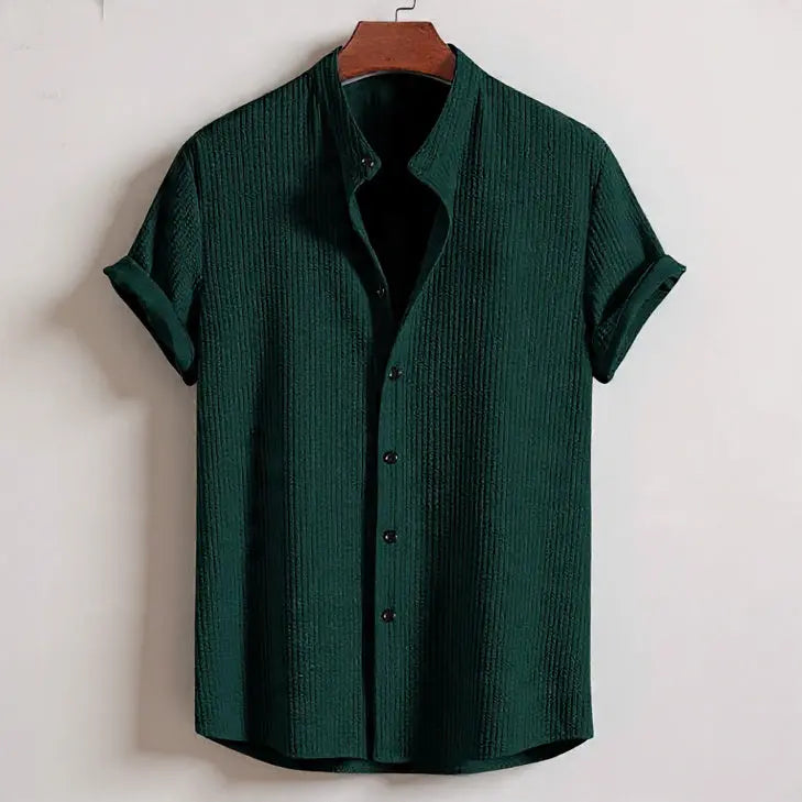 Men's short sleeve loose shirt - dark green textured polyester summer top on hanger against white background