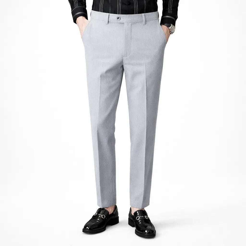 Light gray dress pants worn by a person on a white background