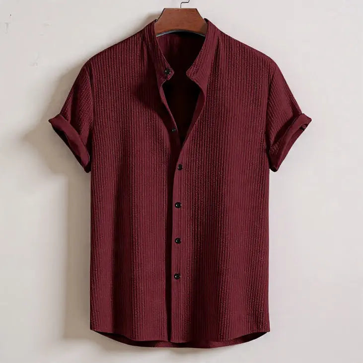 Maroon textured shirt on a hanger against a white background
