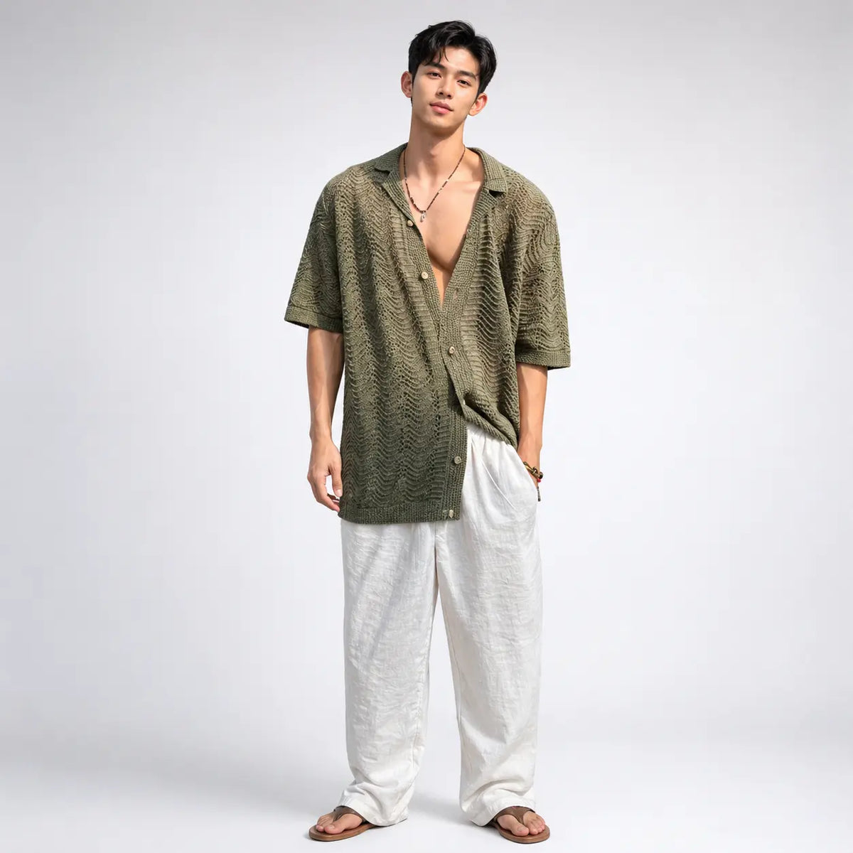 men's green cuban collar knit cardigan in loose fit worn by a model with white pants and sandals