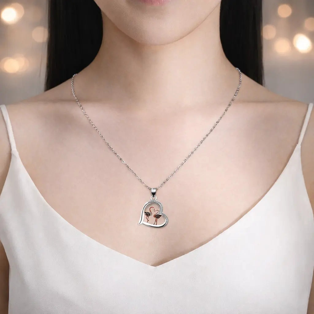 Rose gold swan necklace for women with heart design, worn by a woman in a white top, showcasing the pendant.
