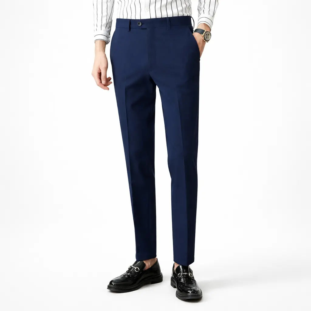 Person wearing navy blue dress pants with a white shirt on a white background