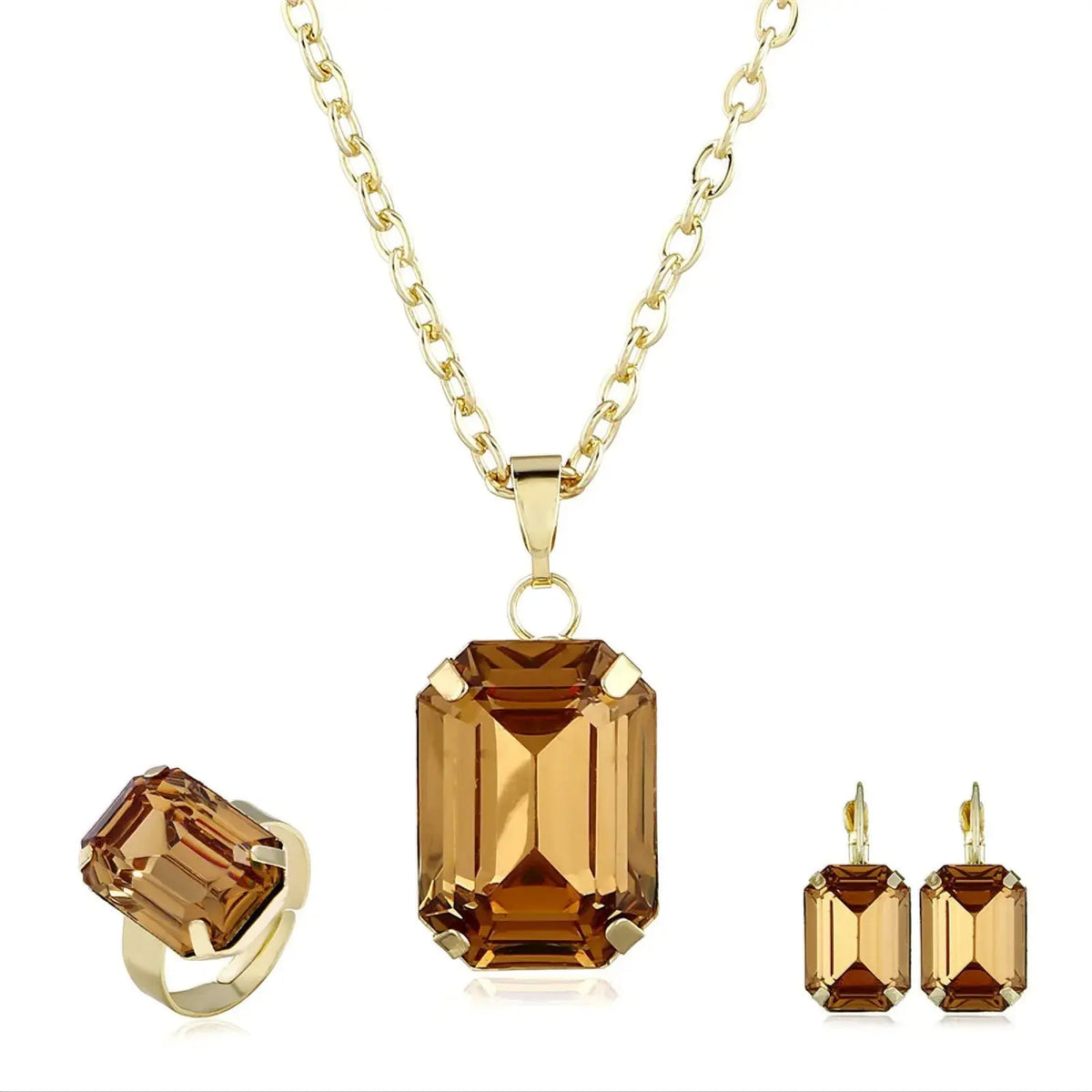 Jewelry set with brown gemstone pendant, ring, and earrings on a white background