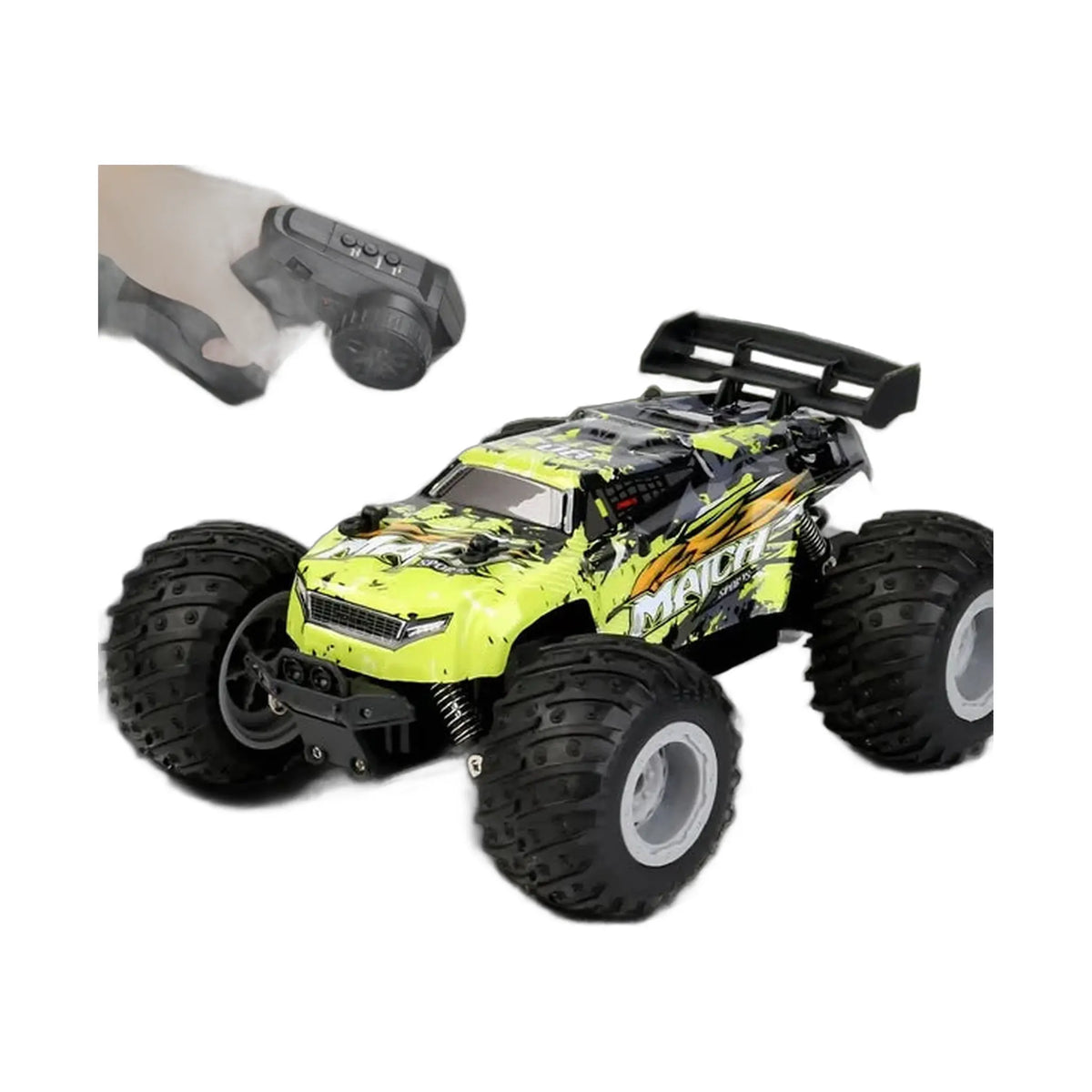 a hand holding a remote control next to a green and black toy car on a road