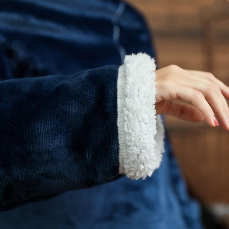 Close-up of a blue garment with white trim on a blurred background