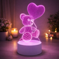 3D LED lamp shaped like a teddy bear with a heart balloon on a wooden surface.  3D Acrylic USB LED Night Lamp – Neon Sign
