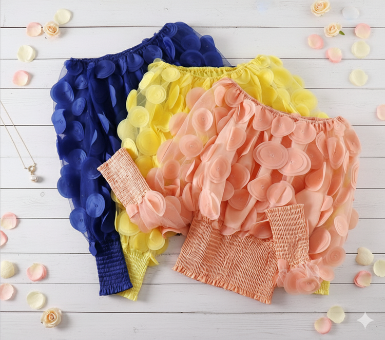 3 Colorful pettiskirts on a white wooden surface with scattered flowers.