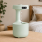 Green electronic device with digital display on a wooden surface, bedroom setting