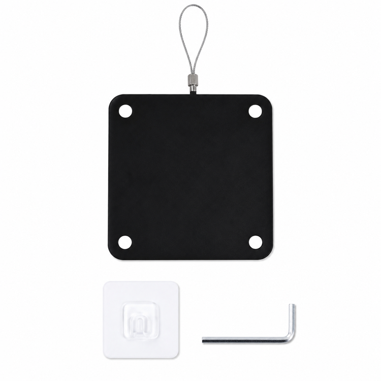 Black square metal plate with holes, white square label, and small tool on a white background