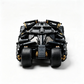 A black and gray toy vehicle model with gold accents, shown from the rear on a clean white background.