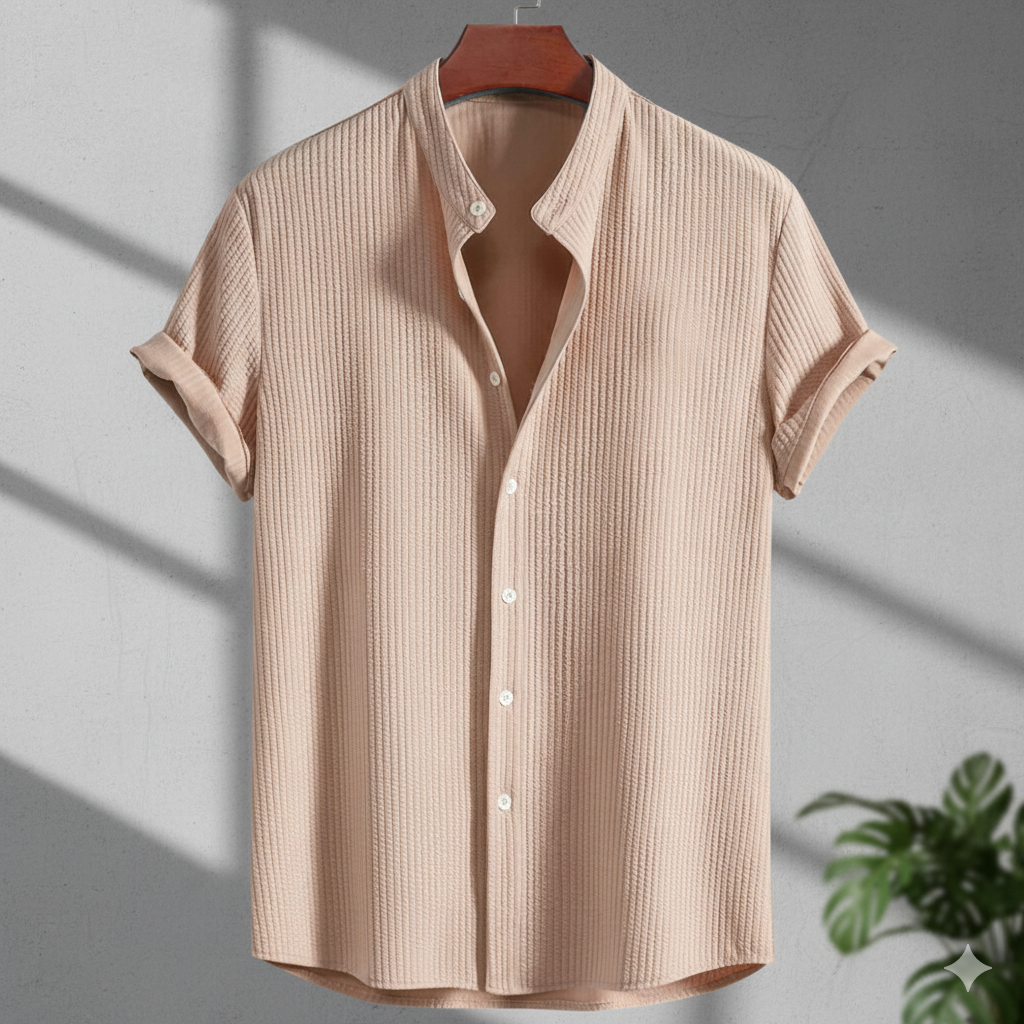 Beige short-sleeve shirt on a hanger with a plant in the corner