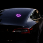 Black car with a pink heart symbol on the hood at night