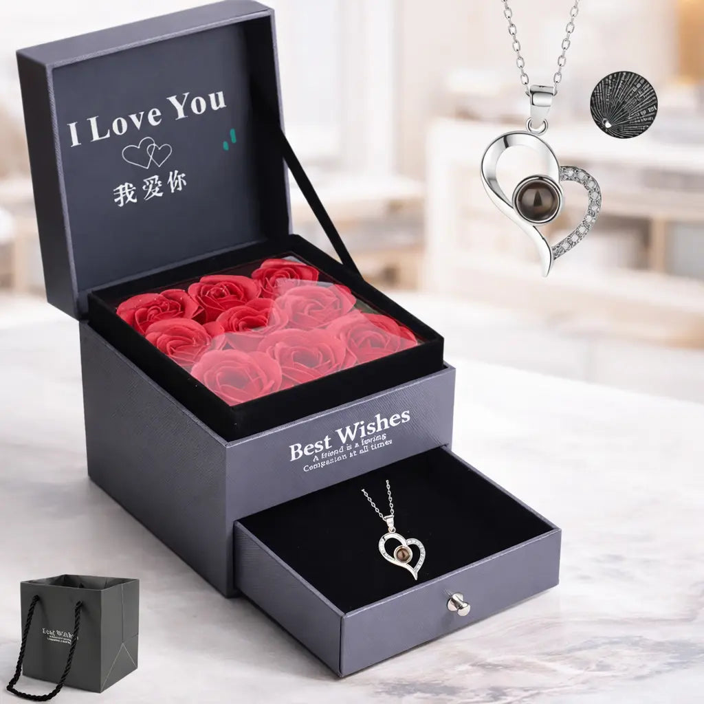 Projection pendant necklace for women shown in silver with a brown gemstone, displayed alongside a gift box filled with red roses.
