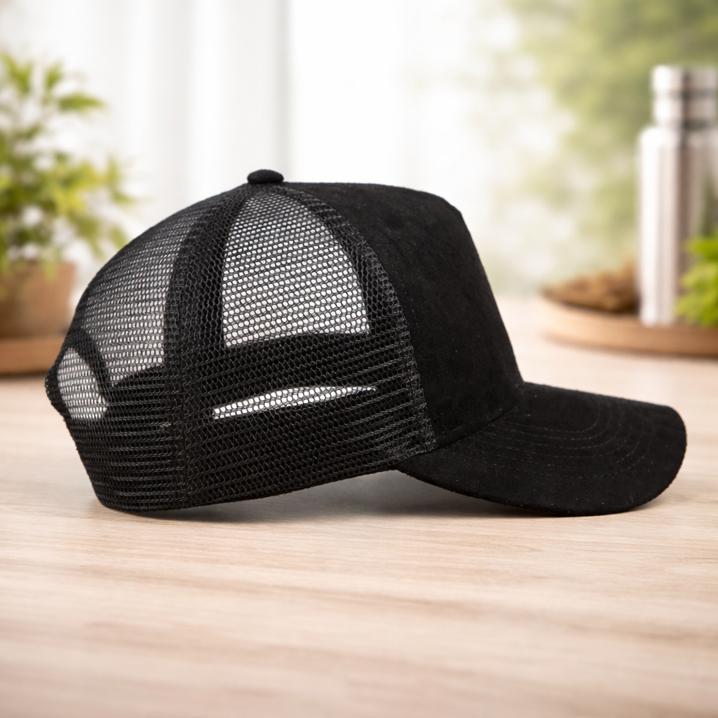 Black mesh cap on a wooden surface with a blurred indoor background