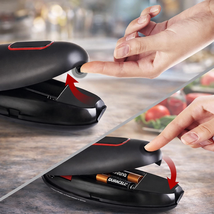 Black office chair with a hand pressing a button, showing Duracell batteries inside.