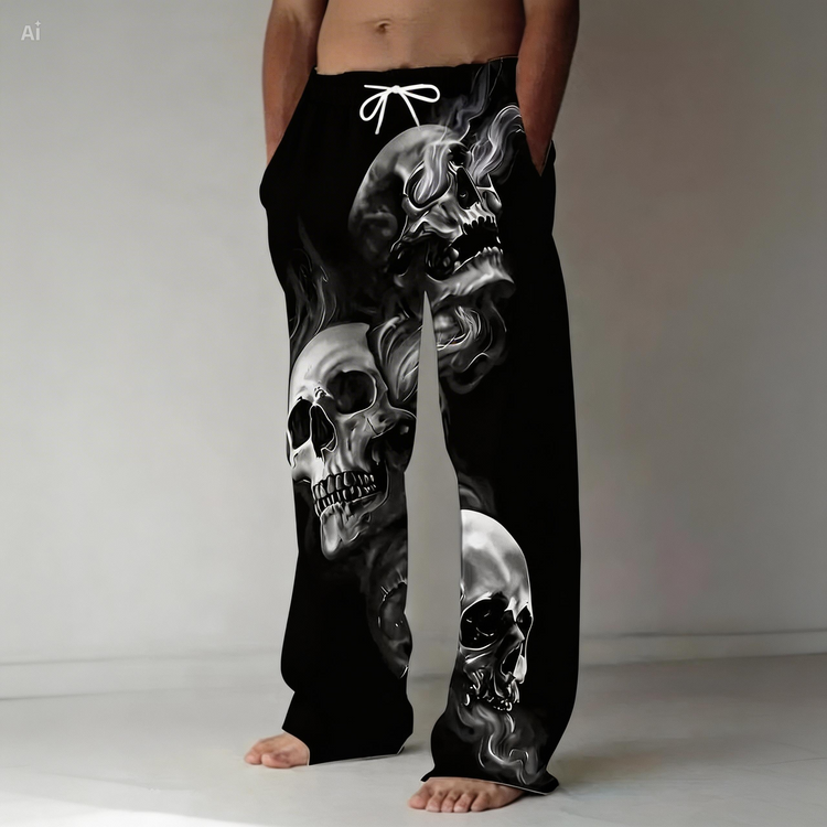 Black pants with skull design worn by a person on a plain background
