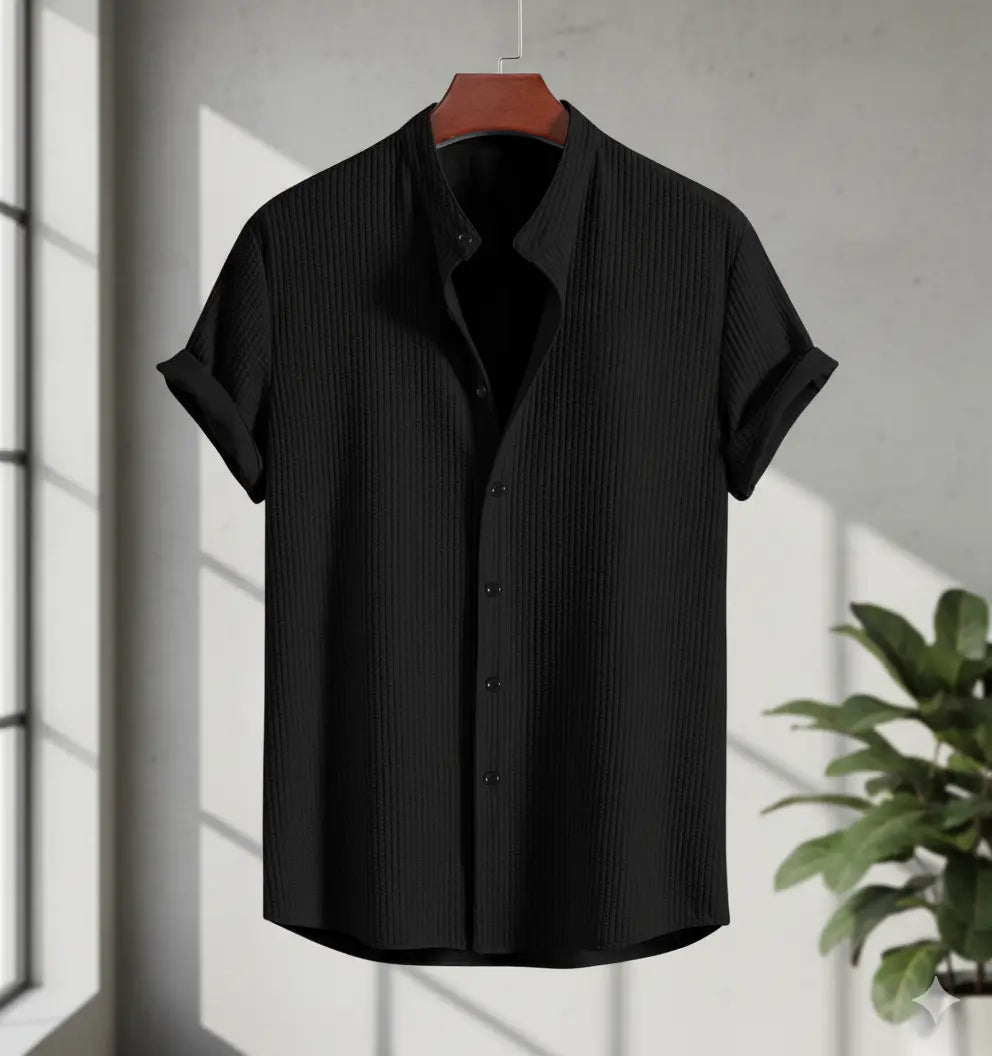 Men's short sleeve loose shirt - black textured polyester summer top on hanger by window with plant