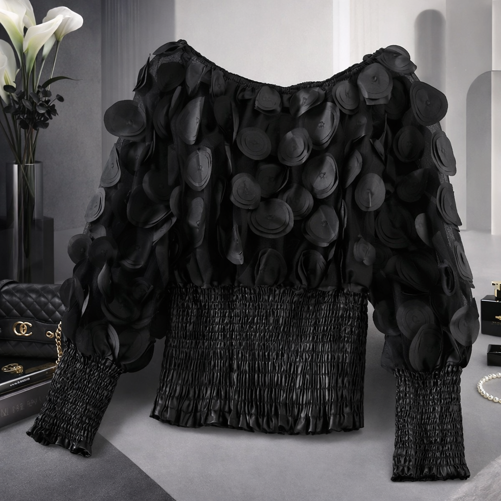 Black textured sweater on a mannequin against a neutral background