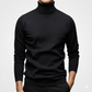 Black turtleneck sweater worn by a person on a light gray background