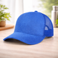 Blue baseball cap on a wooden surface with a blurred background