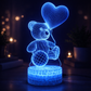 Blue wireframe teddy bear with a heart-shaped balloon on a dark background  3D Acrylic USB LED Night Lamp – Neon Sign
