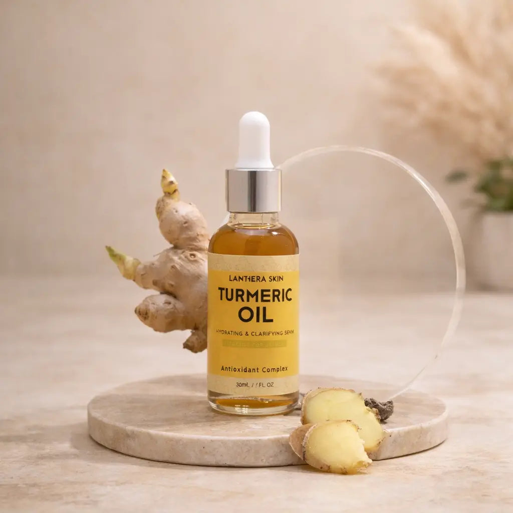 turmeric oil bottle with dropper cap on stone base next to turmeric root slices