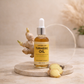 Bottle of Lanthera Skin Turmeric Oil with turmeric root on a wooden surface