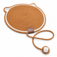Round brown woven mat with a rope handle on a white background