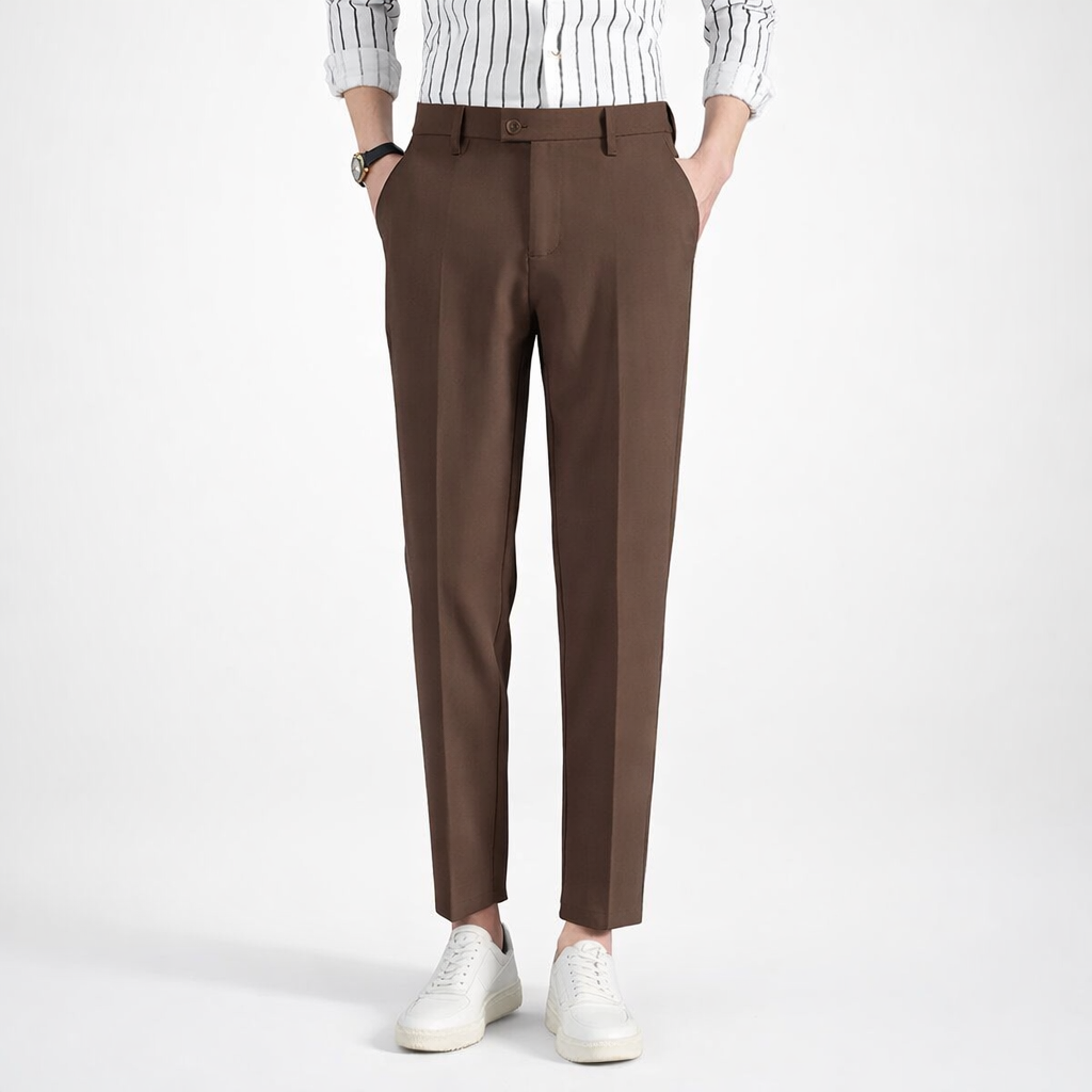 Brown pants worn with a white shirt and white sneakers on a white background