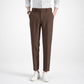 Brown pants worn with a white shirt and white sneakers on a white background