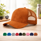 Brown suede cap with mesh back on a wooden surface, surrounded by color swatches.