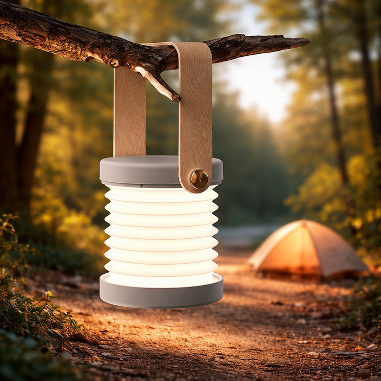 Camping lantern on a branch with a tent in the background