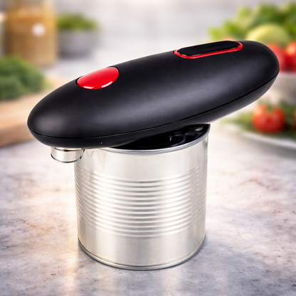 Can opener with a black handle and red button on a metal can, blurred kitchen background