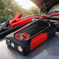 Car jump starter on a car hood with a blurred outdoor background