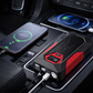 Car jump starter with two smartphones charging inside a vehicle.