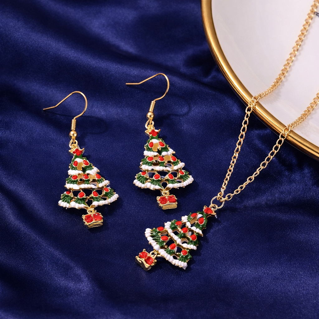 Christmas tree-themed jewelry set with earrings and necklace on a blue fabric background