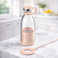 Clear bottle with pink base and cap on a marble surface BLENDER