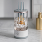 Clear cylindrical device with brushes inside on a marble surface