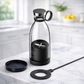Clear water bottle with black base and accessories on a marble surface BLENDER