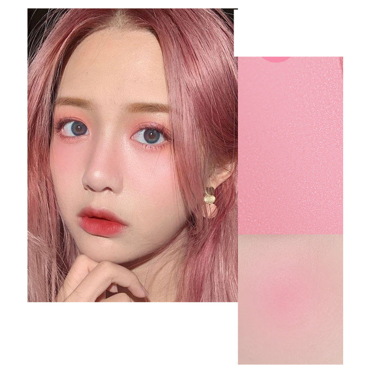 Close-up of a person with pink hair and a color swatch next to it