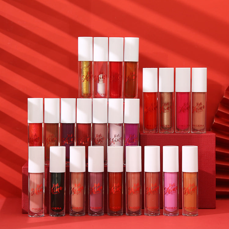 Collection of lip glosses arranged in a pyramid on a red background