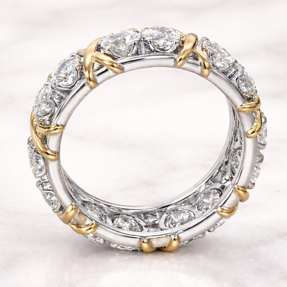 Diamond ring with gold and silver accents on a light gray background