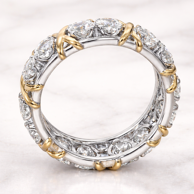 Diamond ring with gold and silver accents on a light gray background