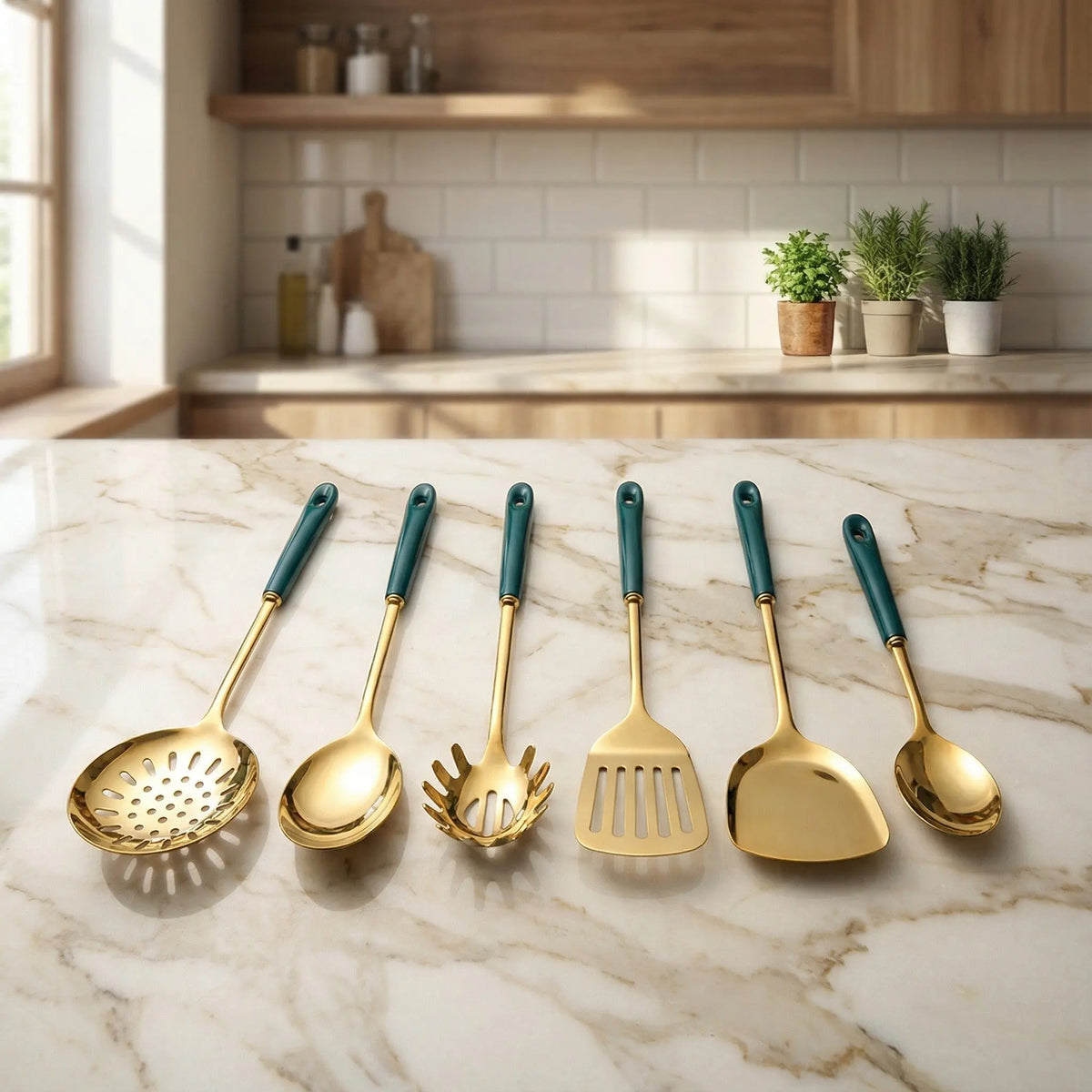 Stainless steel kitchen utensil set with teal handles and gold tools laid out on a marble countertop.
