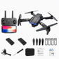 Black quadcopter drone kit with remote controller, smartphone screen, two batteries, four propeller blades, screwdriver, USB cable, carrying case, and instruction manual on a white background.