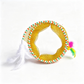 A yellow mesh cat toy tunnel with a striped green, orange, and white trim, featuring two white feathers and a small multicolor feather pom-pom on a white background.