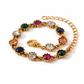 Gold bracelet with multicolored gemstones on a white background